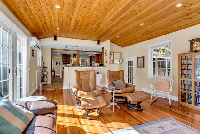 living room with french doors, a wall unit AC, vaulted ceiling, wood finished floors, and wooden ceiling