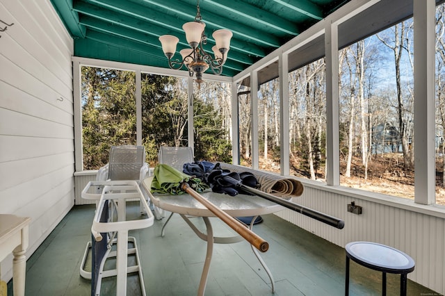 unfurnished sunroom with a notable chandelier and plenty of natural light