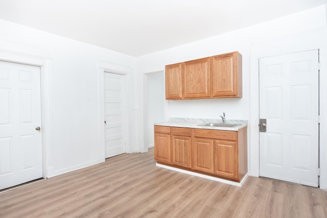 kitchen with sink and light hardwood / wood-style floors