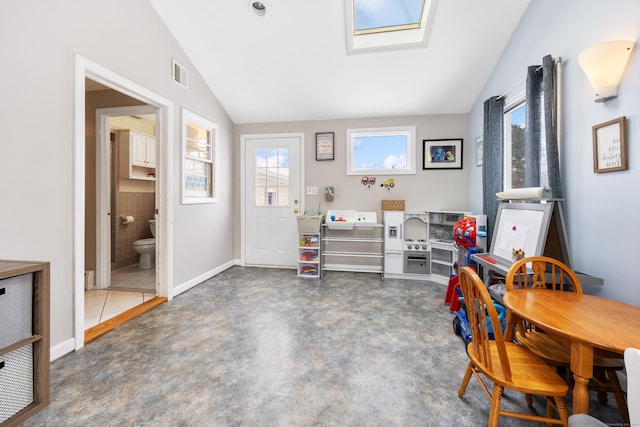 interior space featuring vaulted ceiling with skylight