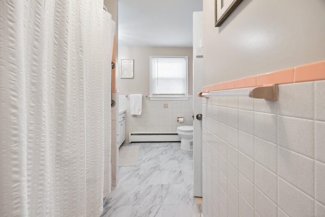 bathroom with a baseboard radiator, tile walls, and toilet