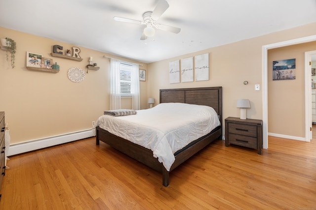 bedroom with baseboard heating, ceiling fan, and light hardwood / wood-style flooring