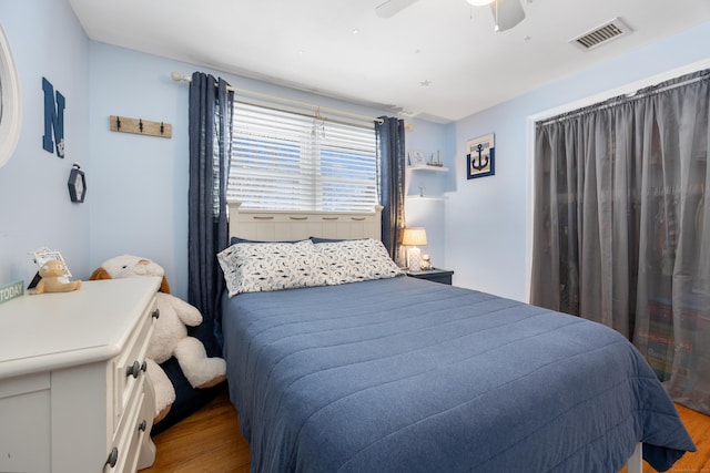 bedroom with ceiling fan and light hardwood / wood-style flooring