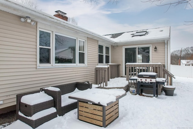 snow covered patio with area for grilling