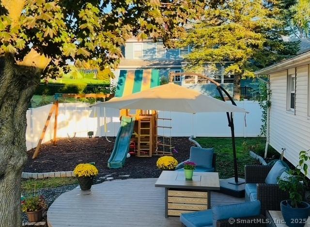 view of jungle gym featuring an outdoor hangout area and a deck