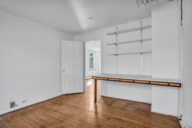 interior space with wood-type flooring and baseboard heating