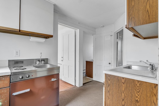 kitchen with a sink, brown cabinets, and light countertops