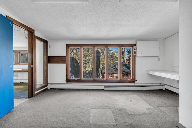 unfurnished room with baseboard heating and a textured ceiling