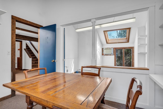 dining space with baseboards, a wall mounted AC, a skylight, stairs, and carpet flooring