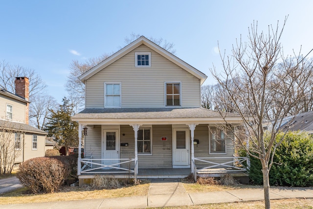 view of front of house featuring covered porch and a shingled roof