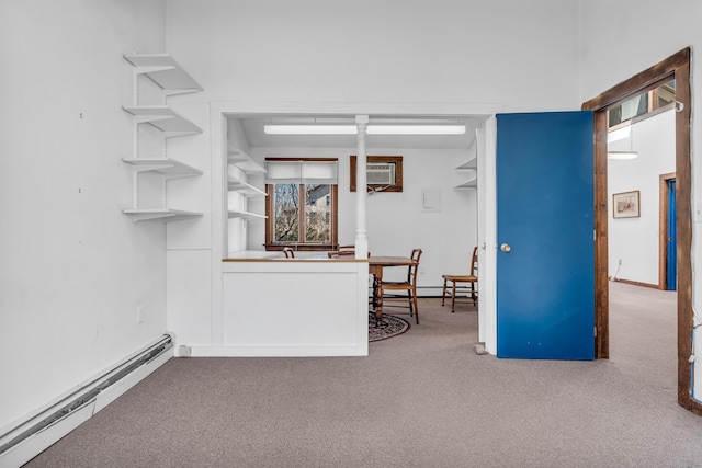 interior space featuring a baseboard heating unit and a wall unit AC