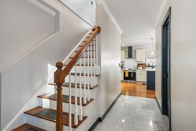 stairway featuring ornamental molding