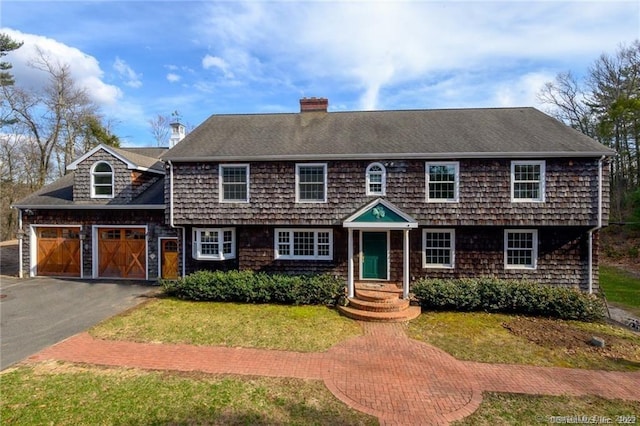 view of front facade with a garage and a front lawn