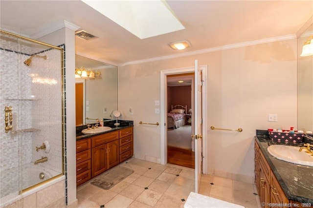 bathroom featuring tiled shower / bath, a skylight, ornamental molding, vanity, and tile patterned floors