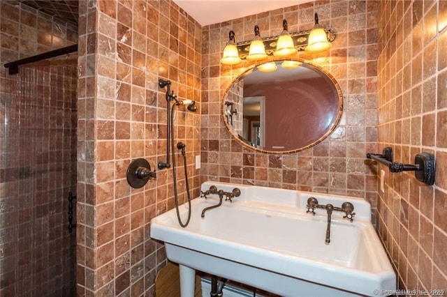 bathroom with sink and tile walls