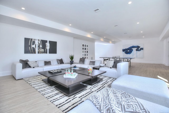 living room with recessed lighting, baseboards, visible vents, and light wood finished floors