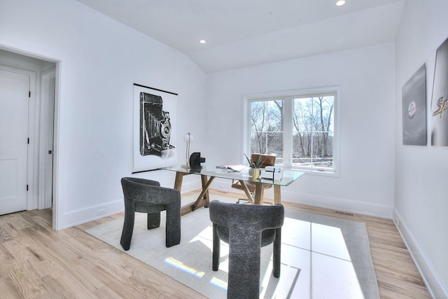 home office with lofted ceiling, light wood-style flooring, and baseboards