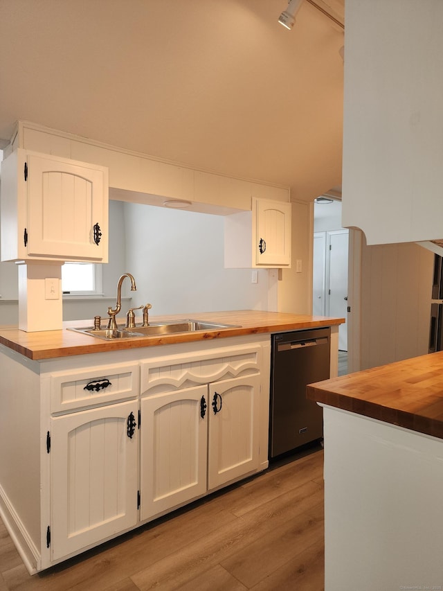 kitchen featuring light wood-style floors, wooden counters, a sink, and dishwasher