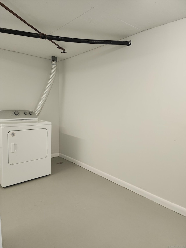 washroom featuring washer / dryer, baseboards, and laundry area
