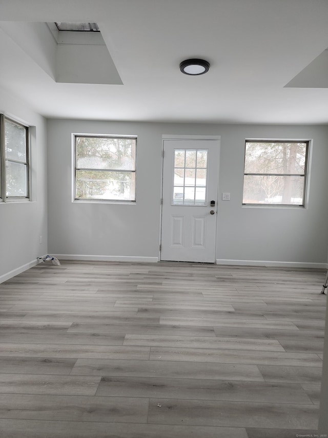 interior space with baseboards and light wood-style floors