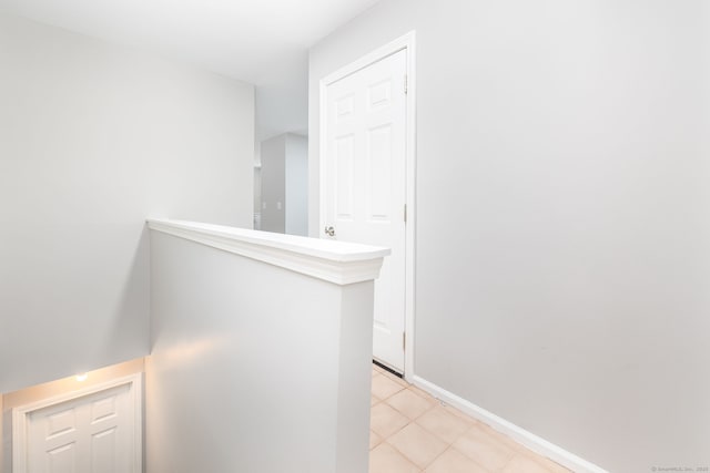 hall with light tile patterned floors