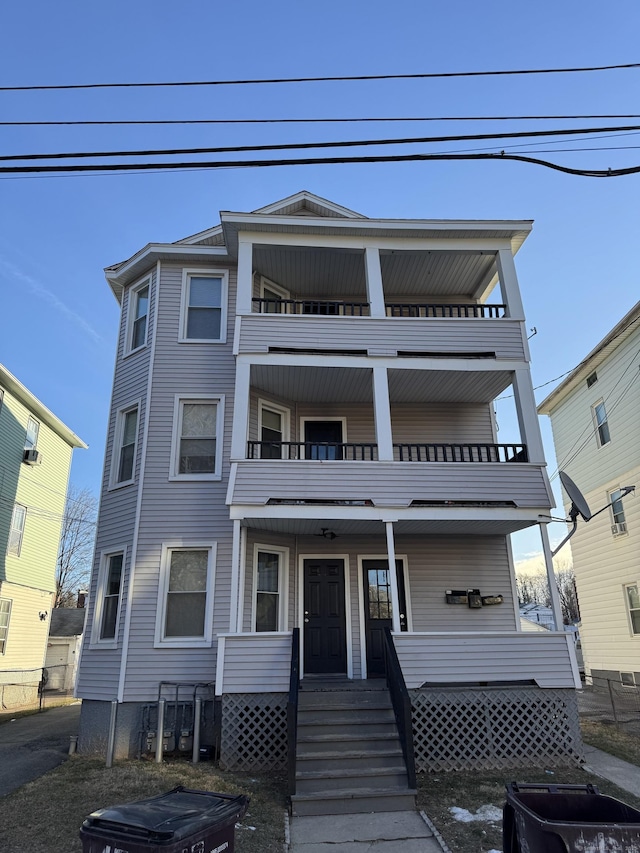 view of front of house with a porch and a balcony