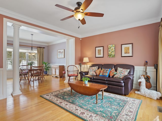 living room featuring decorative columns and light wood-style floors