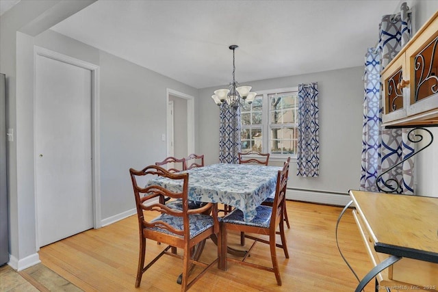 dining room featuring baseboards, light wood finished floors, baseboard heating, and an inviting chandelier