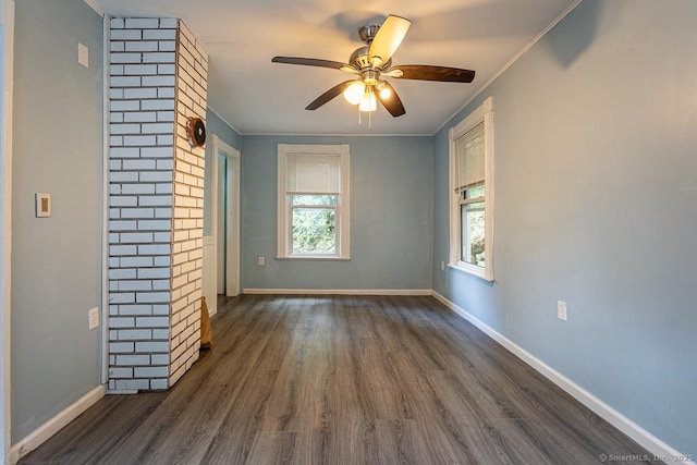 unfurnished living room featuring crown molding, ceiling fan, and dark hardwood / wood-style floors