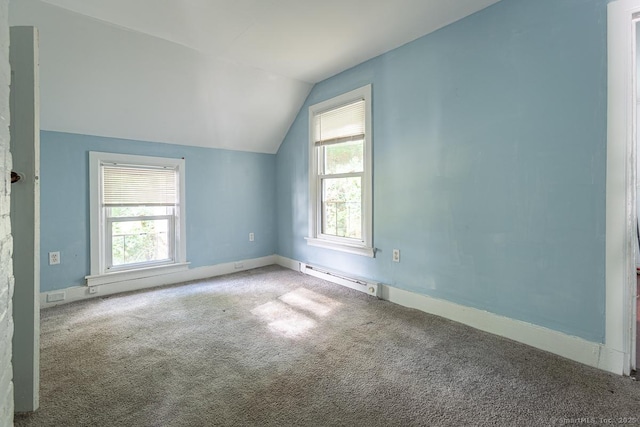 additional living space with lofted ceiling, carpet floors, and a baseboard heating unit