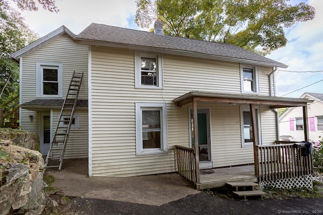 rear view of property with covered porch