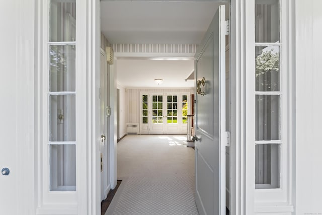 doorway to property featuring radiator heating unit