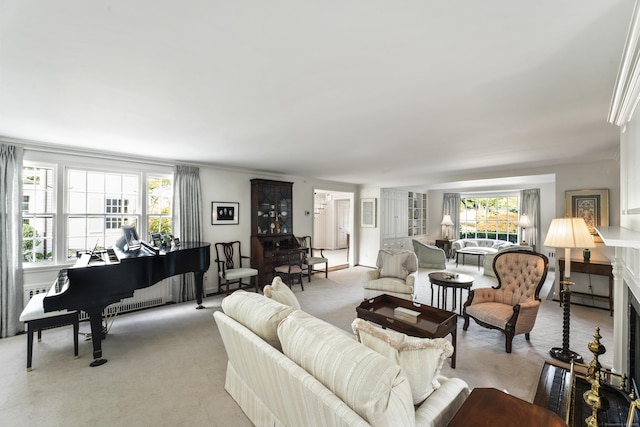 living area featuring light carpet and baseboard heating