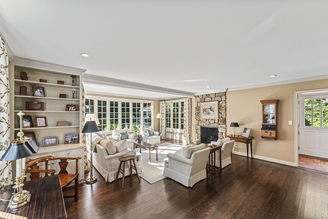 living room featuring ornamental molding, a fireplace, baseboards, and dark wood-style floors