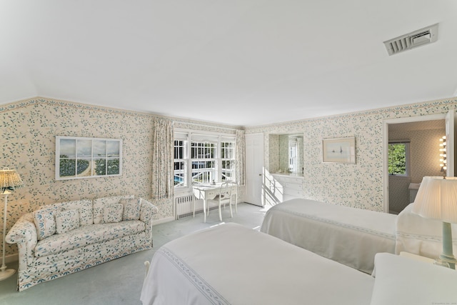 bedroom with lofted ceiling, light colored carpet, visible vents, radiator heating unit, and wallpapered walls