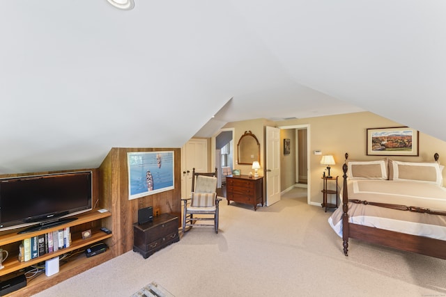 bedroom with lofted ceiling, baseboards, and light colored carpet