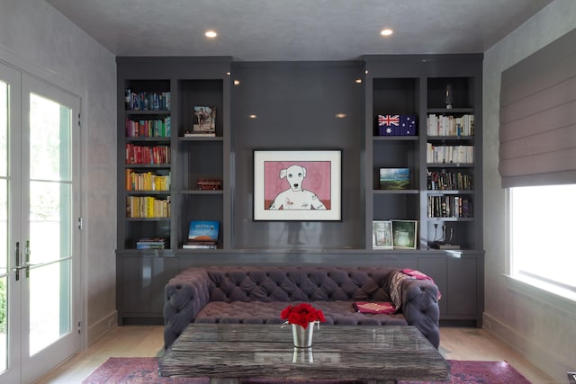 living area featuring built in shelves and french doors