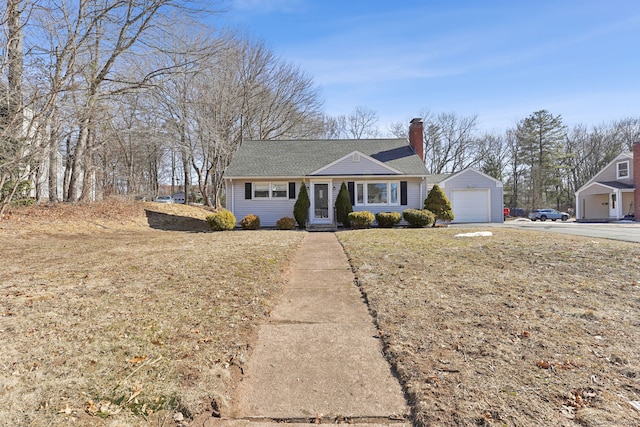 single story home featuring driveway, a chimney, and an outdoor structure