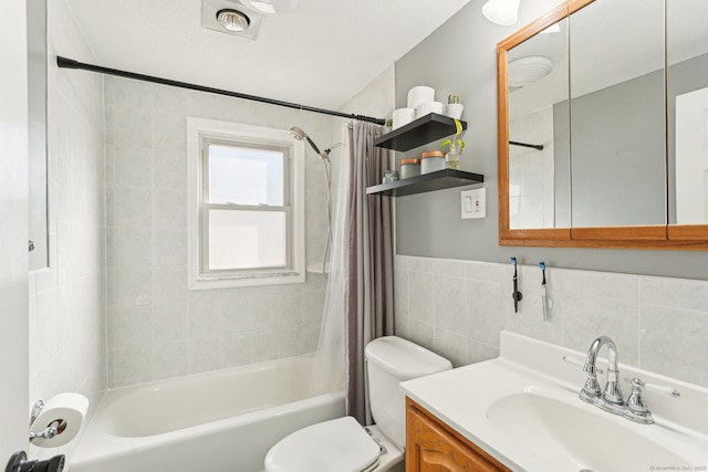 full bathroom featuring toilet, shower / bath combo, tile walls, and vanity