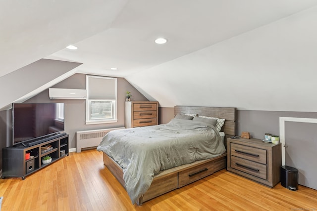 bedroom with a wall unit AC, hardwood / wood-style flooring, radiator heating unit, lofted ceiling, and recessed lighting