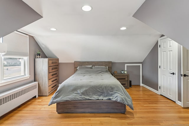 bedroom with recessed lighting, baseboards, vaulted ceiling, light wood-type flooring, and radiator