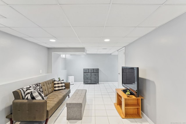 living room featuring a paneled ceiling, light tile patterned floors, baseboards, and recessed lighting