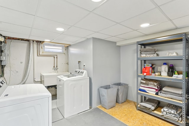 laundry room featuring recessed lighting, laundry area, independent washer and dryer, and a sink