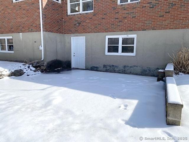 view of snow covered property entrance