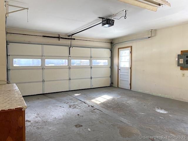 garage featuring a garage door opener and electric panel