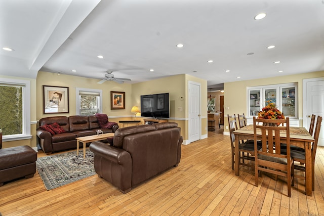 living room featuring ceiling fan and light hardwood / wood-style flooring