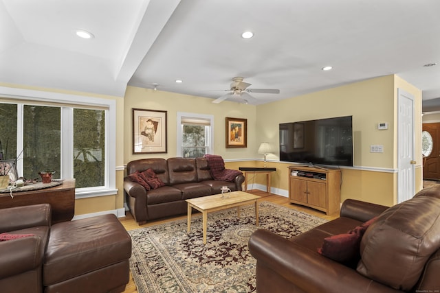 living room with light hardwood / wood-style flooring and ceiling fan