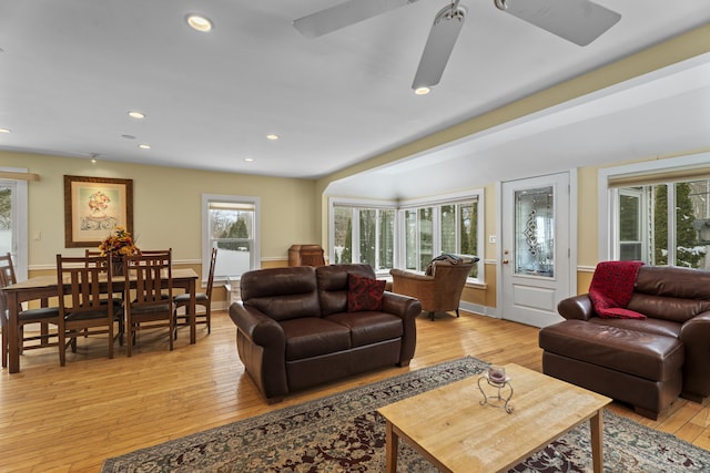 living room with ceiling fan and light hardwood / wood-style flooring