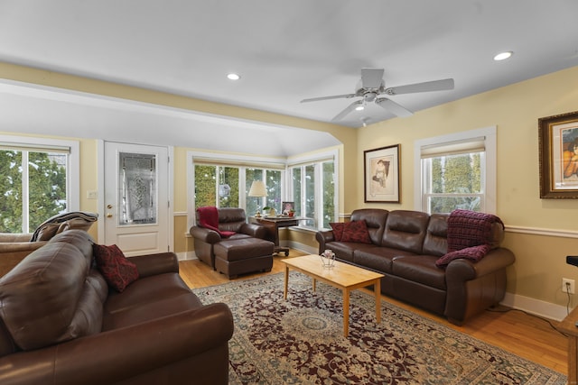 living room featuring plenty of natural light, ceiling fan, and light hardwood / wood-style flooring