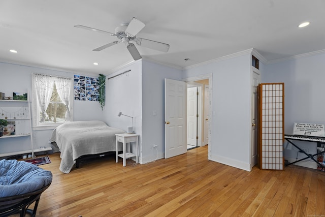 bedroom with crown molding, ceiling fan, and light hardwood / wood-style flooring